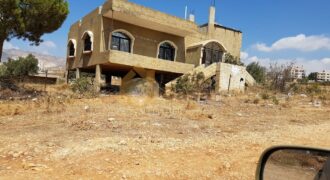 land for sale in zahle with shops and apartment on it .