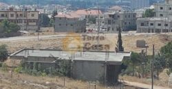 land for sale in zahle with shops and apartment on it .