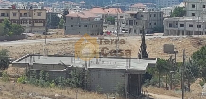 land for sale in zahle with shops and apartment on it .