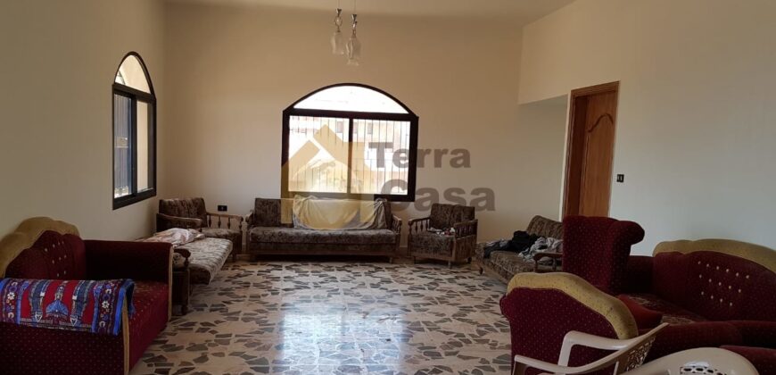 land for sale in zahle with shops and apartment on it .